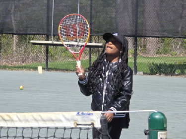 student playing tennis